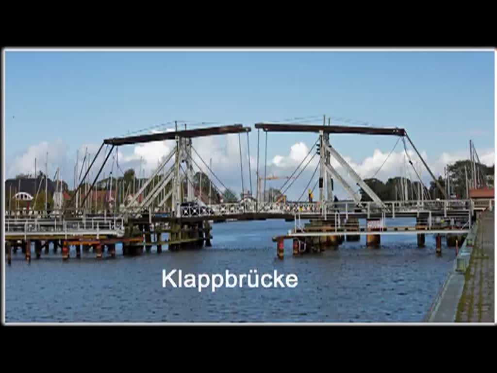 Die kurz vor der Sanierung und somit vor der Sperrung stehende Holzklappbrücke im Hafen von Greifswald-Wieck wird für drei Boote geöffnet.
Zur Instandsetzung der denkmalgeschützten Klappbrücke wurde für Fussgänger eine Behelfsbrücke eingerichtet (Titelbild). - 25.09.2014